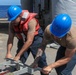Sailors aboard the USS Howard conduct a torpedo download in the East China Sea