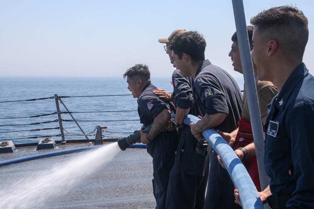 Sailors aboard the USS Howard conduct a freshwater washdown in Sagami Wan