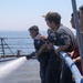 Sailors aboard the USS Howard conduct a freshwater washdown in Sagami Wan