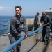 Sailors aboard the USS Howard conduct a freshwater washdown in Sagami Wan