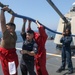 Sailors aboard the USS Howard conduct a freshwater washdown in Sagami Wan