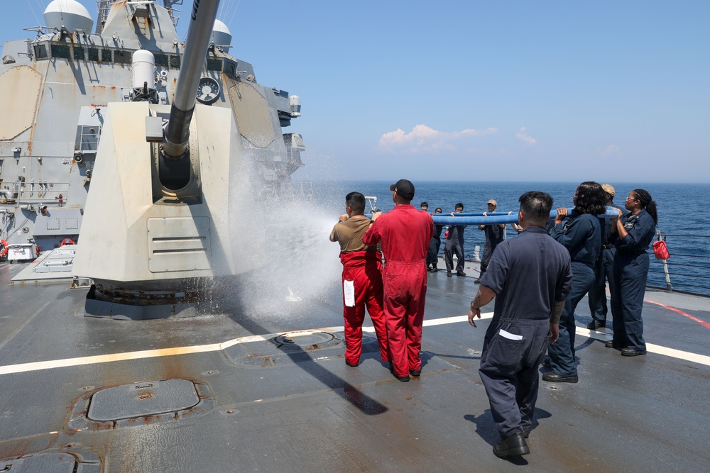 Sailors aboard the USS Howard conduct a freshwater washdown in Sagami Wan