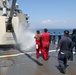 Sailors aboard the USS Howard conduct a freshwater washdown in Sagami Wan
