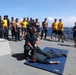 Sailors aboard the USS Howard conduct a sea contamination exercise in the Philippine Sea