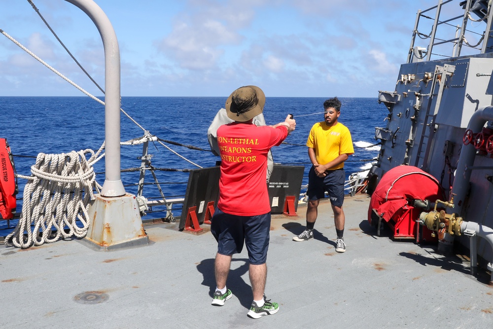 Sailors aboard the USS Howard conduct a sea contamination exercise in the Philippine Sea