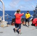 Sailors aboard the USS Howard conduct a sea contamination exercise in the Philippine Sea