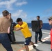 Sailors aboard the USS Howard conduct a sea contamination exercise in the Philippine Sea