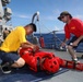 Sailors aboard the USS Howard conduct a sea contamination exercise in the Philippine Sea