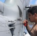 Sailors aboard the USS Howard conduct routine maintenance on a Sea Hawk helicopter (MH-60R) in the Philippine Sea