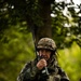 Bosnian soldier communicates with team while holding security