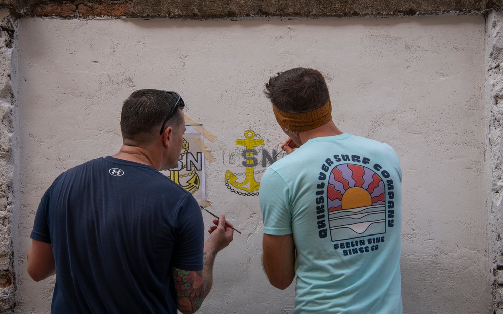 NAS Sigonella Sailors volunteer for a local school clean-up efforts.