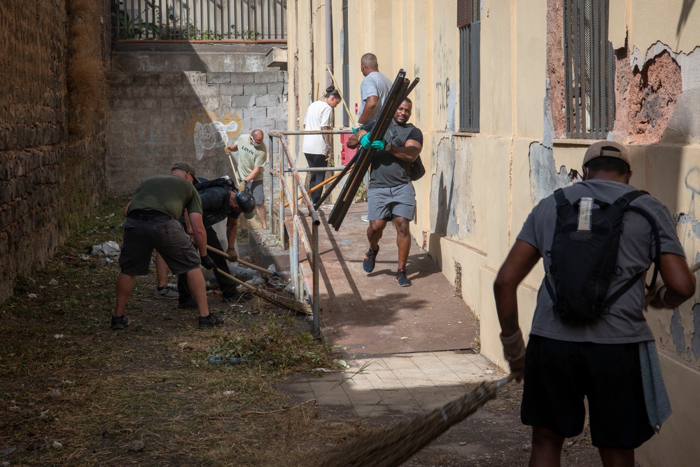 NAS Sigonella Sailors volunteer for a local school clean-up efforts.