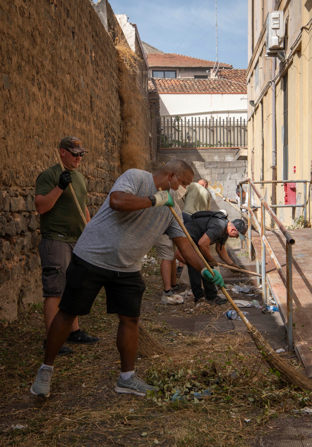 NAS Sigonella Sailors volunteer for a local school clean-up efforts.