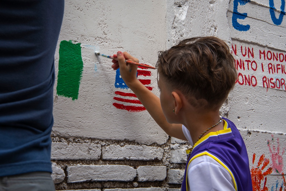 NAS Sigonella Sailors volunteer for a local school clean-up efforts.