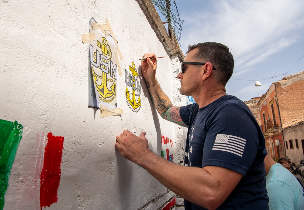 NAS Sigonella Sailors volunteer for a local school clean-up efforts.