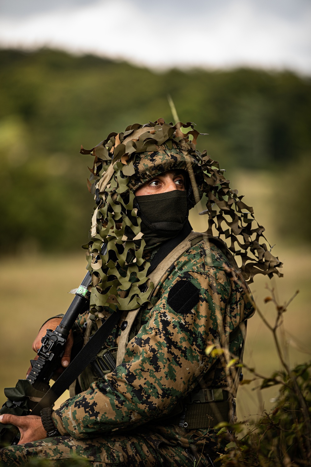 Bosnian soldier guards prisoners during training exercise