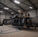 U.S. Soldiers salvage parts from Black Hawk helicopter