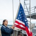 A Nimitz Sailor Raises the Ensign