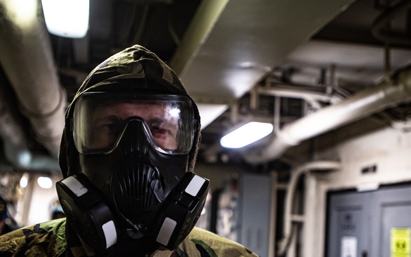 A Nimitz Sailor Dons J-List Gear During Simulation