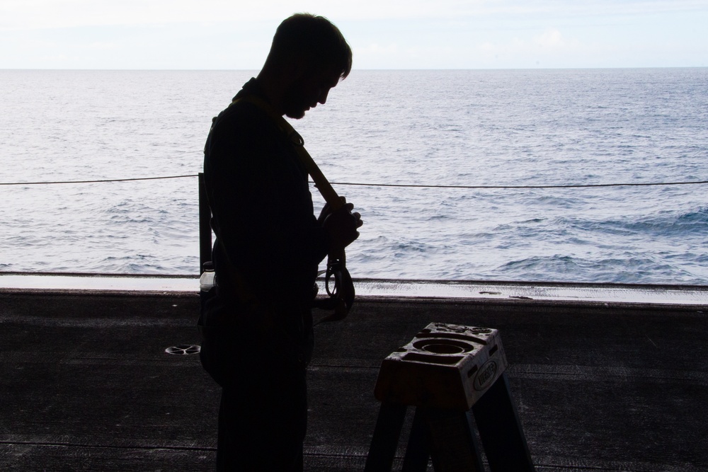 A Nimitz Sailor Adjusts Safety Harness