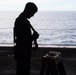 A Nimitz Sailor Adjusts Safety Harness