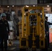 Nimitz Sailors Guide a Forklift Through the Hangar Bay