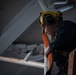 A Nimitz Sailor Paints in the Hangar Bay