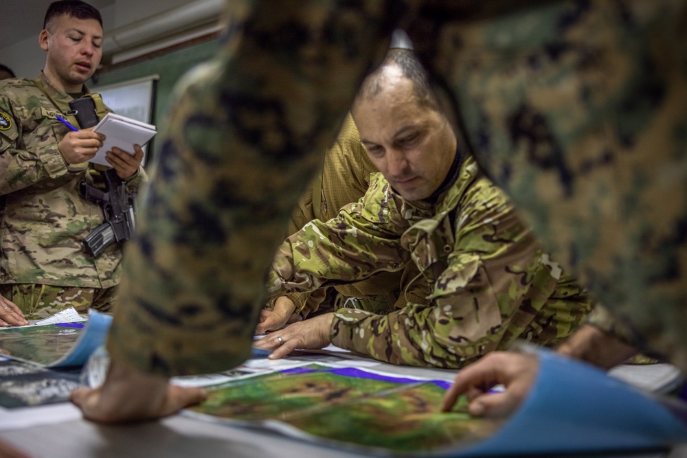 U.S. Marine Corps Mountain Warfare Instructors conduct long-range movement with Argentine marines