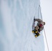 U.S. Marine Corps Mountain Warfare Instructors climb an ice wall with Argentine marines