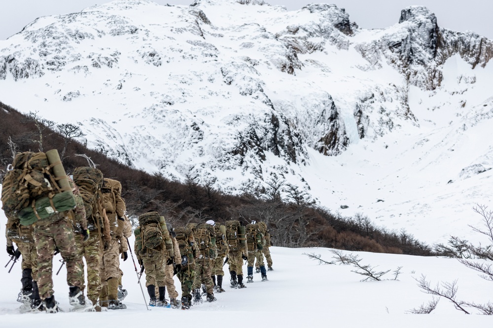 U.S. Marine Corps Mountain Warfare Instructors climb an ice wall with Argentine marines