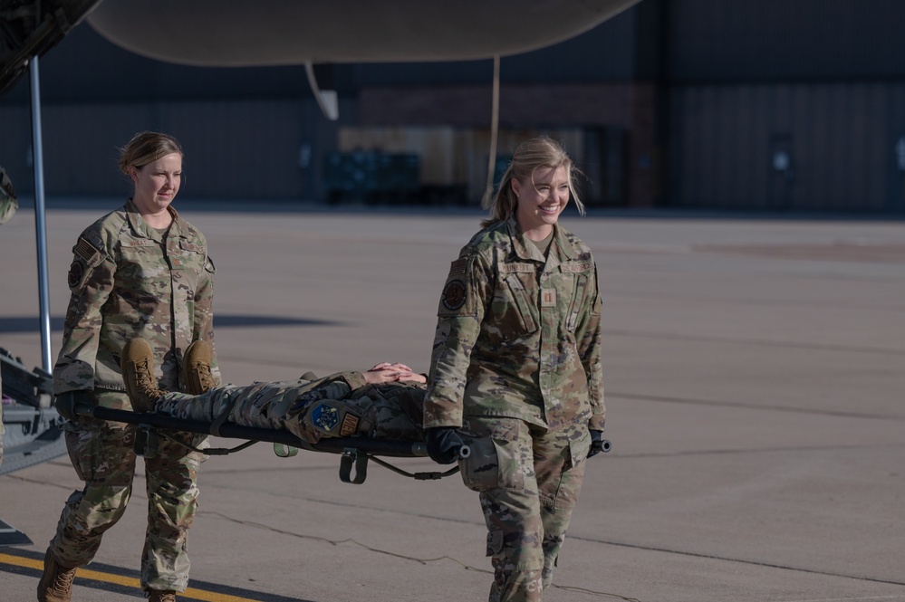Members from the 21st Medical Group and the 21st Security Forces Squadron recently partnered with the 302nd Aeromedical Evacuation Squadron to conduct Medic-X training, where they practiced patient on-loading and off-loading from aircraft.