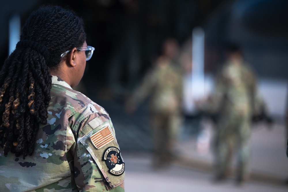 Members from the 21st Medical Group and the 21st Security Forces Squadron recently partnered with the 302nd Aeromedical Evacuation Squadron to conduct Medic-X training, where they practiced patient on-loading and off-loading from aircraft.