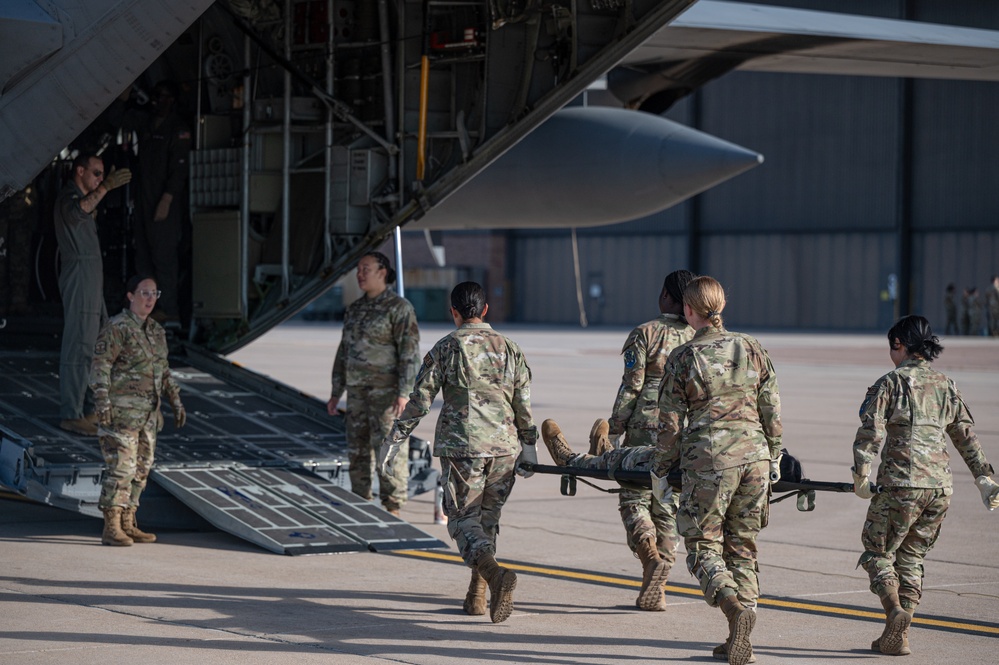 Members from the 21st Medical Group and the 21st Security Forces Squadron recently partnered with the 302nd Aeromedical Evacuation Squadron to conduct Medic-X training, where they practiced patient on-loading and off-loading from aircraft.