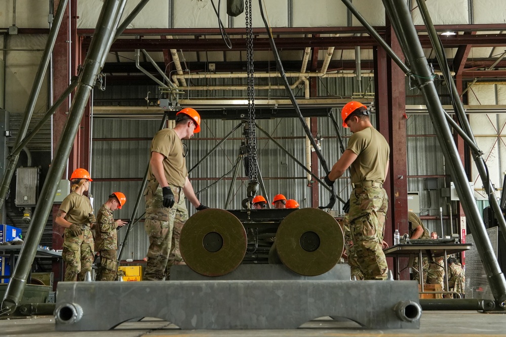 Two airmen prepare to load BLU-109, 2000lb ordnance onto the Munitions Assembly Conveyor during the 7th annual AMMO Rodeo bomb building competition at Volk Field, WI.