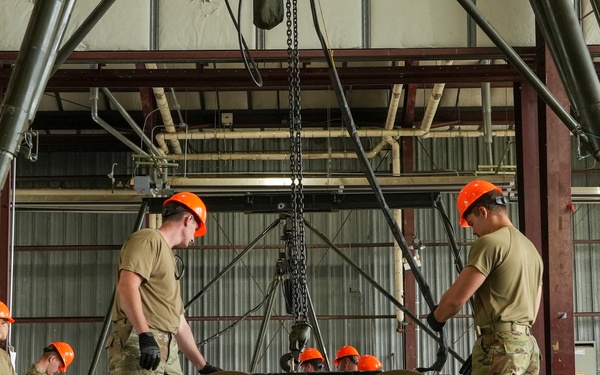 Two airmen prepare to load BLU-109, 2000lb ordnance onto the Munitions Assembly Conveyor during the 7th annual AMMO Rodeo bomb building competition at Volk Field, WI.