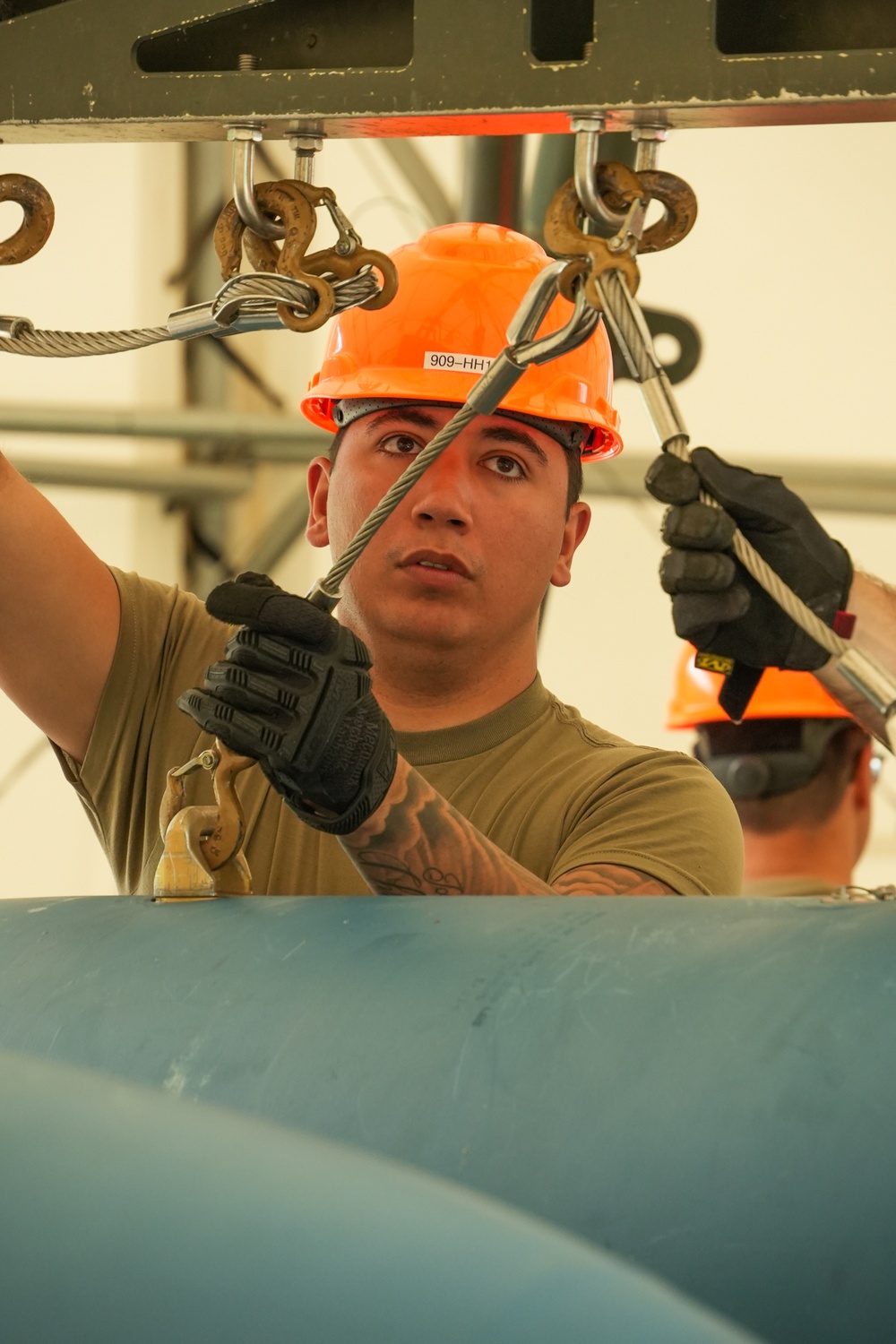 Staff Sgt. Matthew Garcia, assigned to the 5th Bomb Wing at Minot Air Force Base, N.D., attaches slings to a 2,000-lb, Mark-84 general purpose heavy unguided bomb body during the 2024 Ammo Rodeo at Volk Field, Wis.