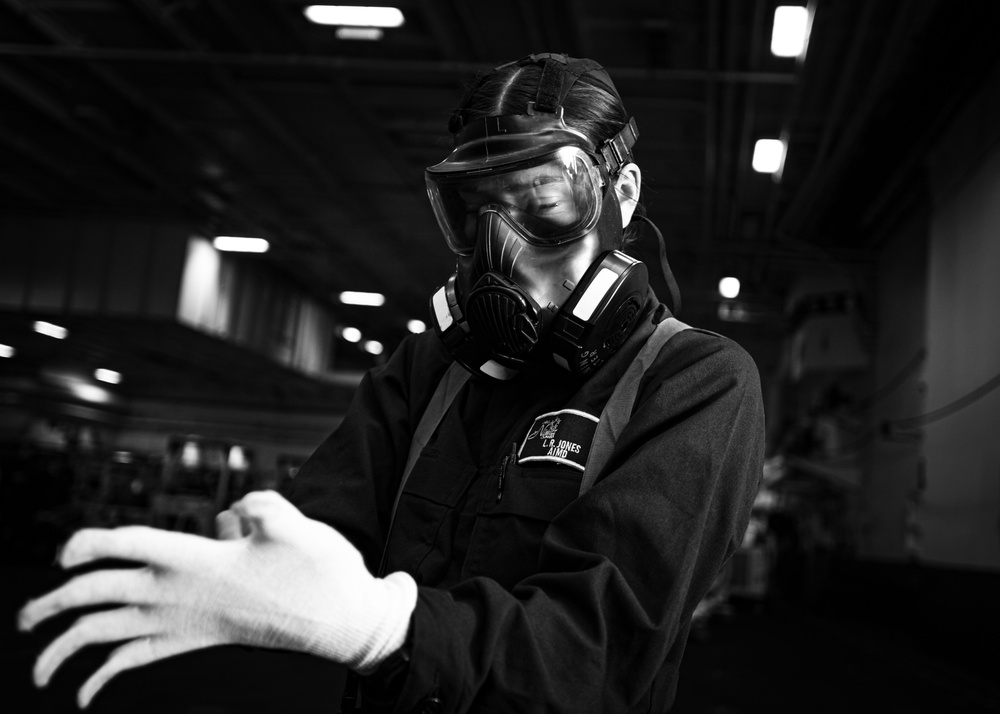 A Nimitz Sailor Dons a JSLIST During a General Quarters Drill