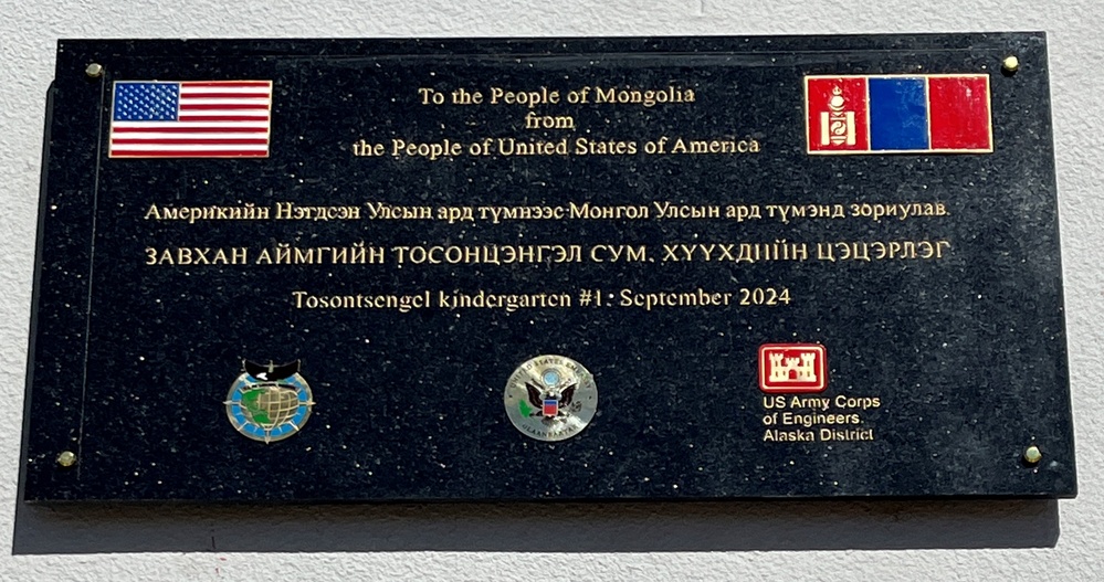 A commemorative plaque is visible outside the newly constructed kindergarten in Tosontsengel