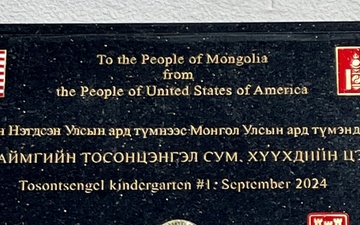 A commemorative plaque is visible outside the newly constructed kindergarten in Tosontsengel