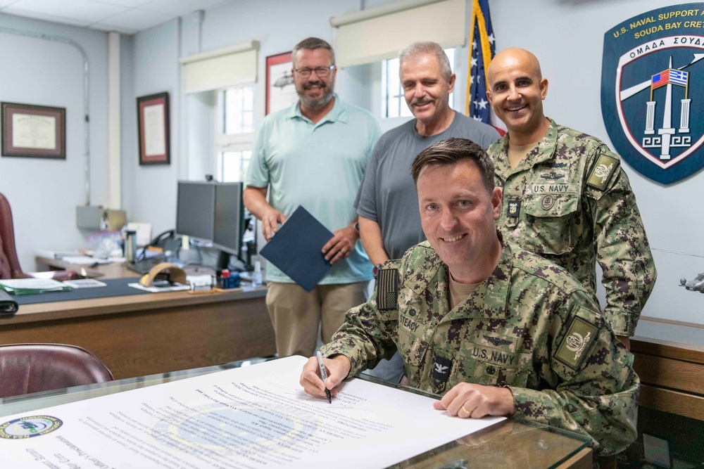 NSA Souda Bay Commanding Officer Capt. Stephen Steacy signs proclamation recognizing nation preparedness month.