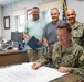 NSA Souda Bay Commanding Officer Capt. Stephen Steacy signs proclamation recognizing nation preparedness month.