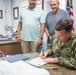 NSA Souda Bay Commanding Officer Capt. Stephen Steacy signs proclamation recognizing nation preparedness month.