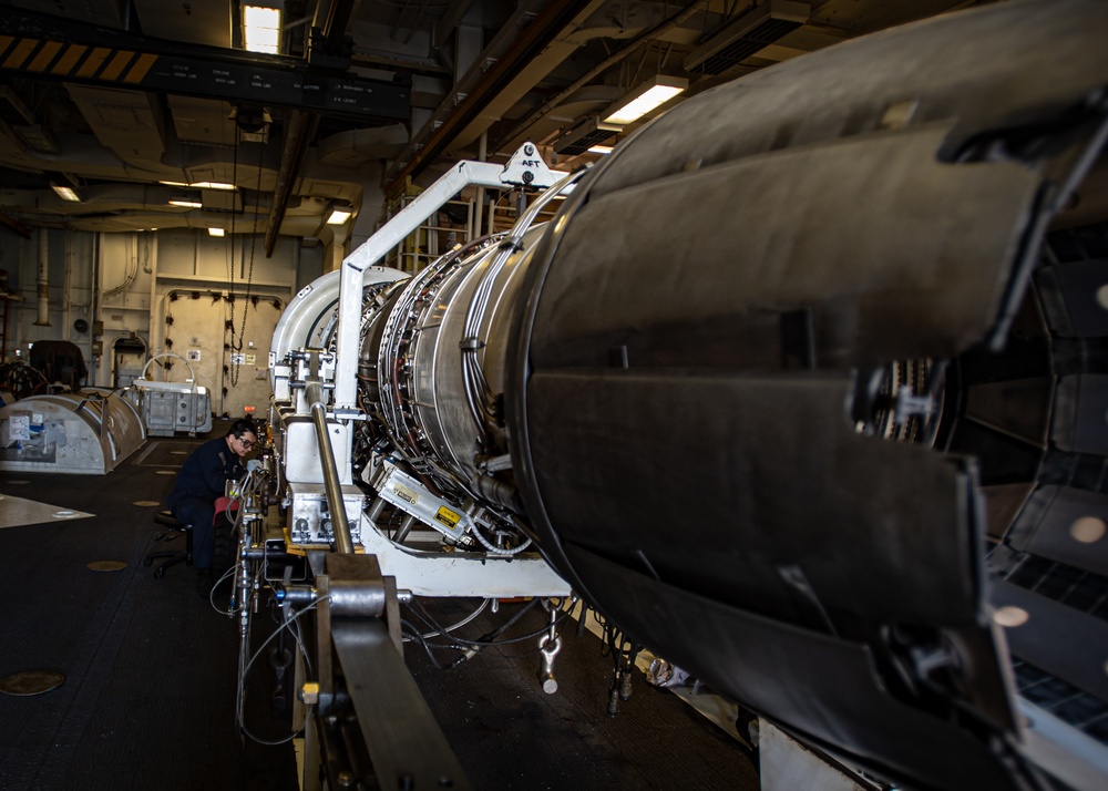 Nimitz Sailor Conducts Maintenance on a Jet Engine