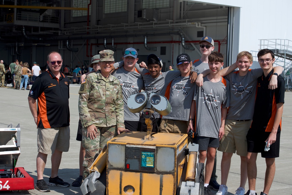 Brigadier General Diane Dunn, Adjutant General, Maine National Guard, poses for a photo with the Brewer High School robotic team at the 101st Air Refueling Wing family day event, Sept. 15, 2024, Bangor, Me.