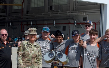 Brigadier General Diane Dunn, Adjutant General, Maine National Guard, poses for a photo with the Brewer High School robotic team at the 101st Air Refueling Wing family day event, Sept. 15, 2024, Bangor, Me.