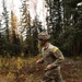 U.S. Soldier Running Through Forest in Best Medic Competition