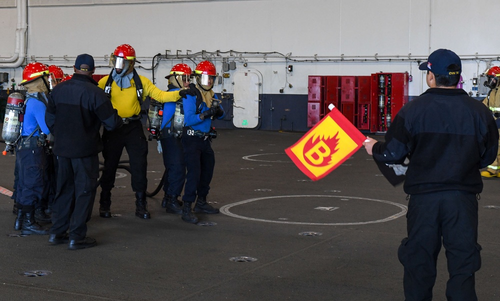 USS Ronald Reagan (CVN 76) Sailors conduct training during a general quarters drill