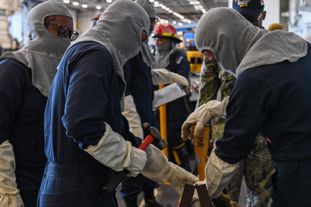 USS Ronald Reagan (CVN 76) Sailors conduct training during a general quarters drill