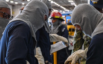 USS Ronald Reagan (CVN 76) Sailors conduct training during a general quarters drill