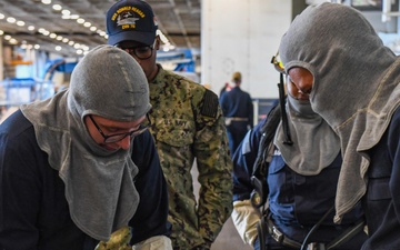 USS Ronald Reagan (CVN 76) Sailors conduct training during a general quarters drill